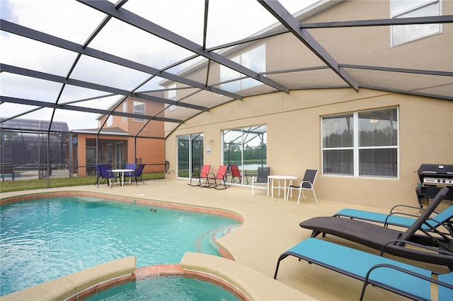 view of pool featuring area for grilling, an in ground hot tub, glass enclosure, a sunroom, and a patio area