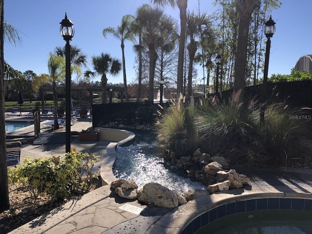 exterior space featuring a community pool and a patio area