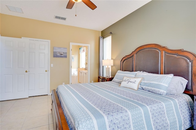 tiled bedroom featuring ceiling fan, connected bathroom, and a closet