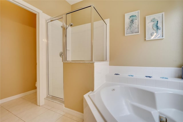 bathroom with tile patterned floors, toilet, and separate shower and tub