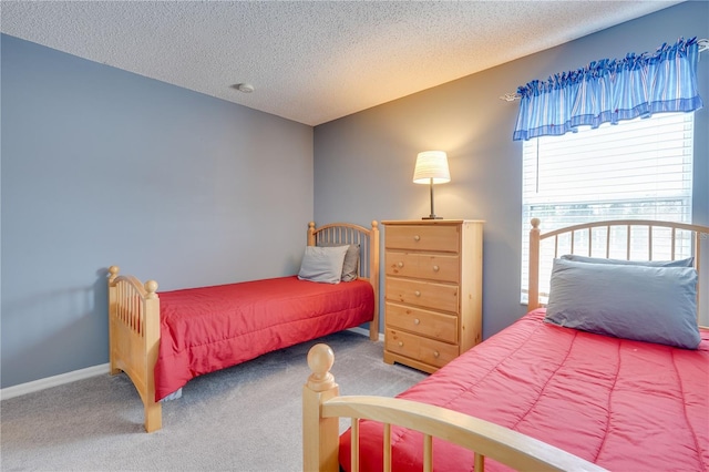 carpeted bedroom featuring a textured ceiling