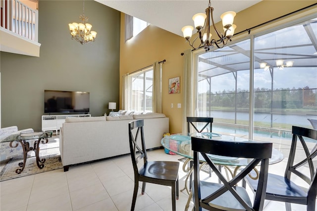 dining space featuring an inviting chandelier, a water view, and light tile patterned floors