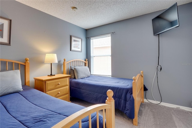 bedroom with carpet floors and a textured ceiling