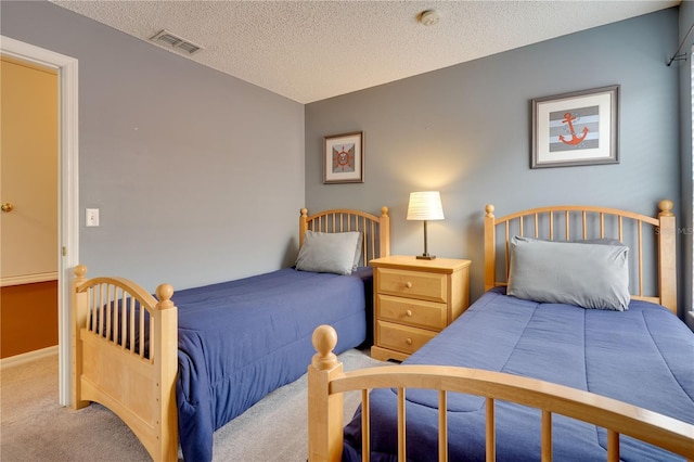 bedroom featuring light carpet and a textured ceiling