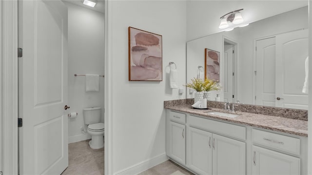 bathroom with vanity, toilet, and tile patterned flooring