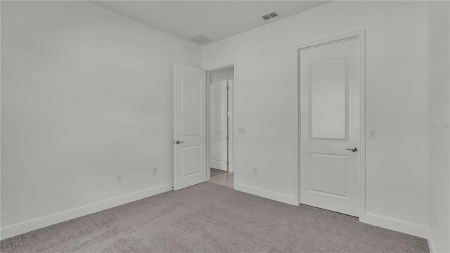 unfurnished bedroom with light carpet