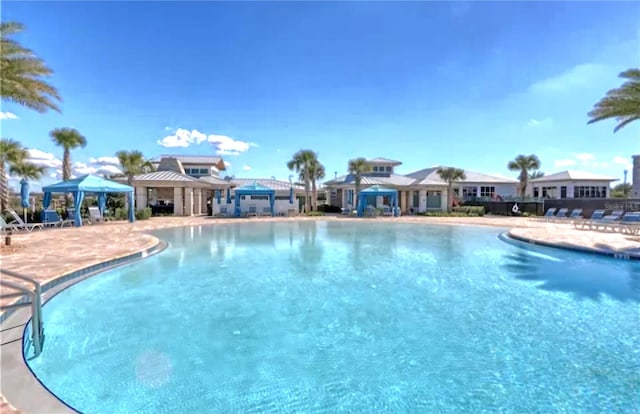 view of swimming pool featuring a gazebo and a patio