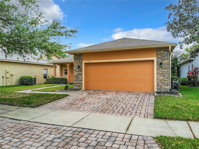 view of front of house featuring a front yard and a garage