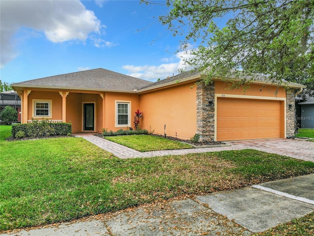 view of front of home with a front yard and a garage