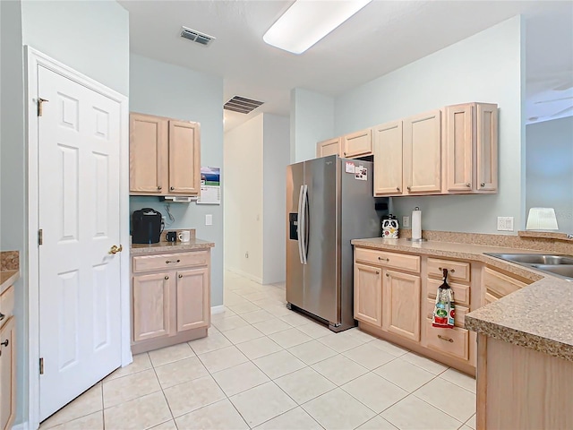 kitchen featuring sink, light brown cabinets, stainless steel fridge with ice dispenser, and light tile flooring