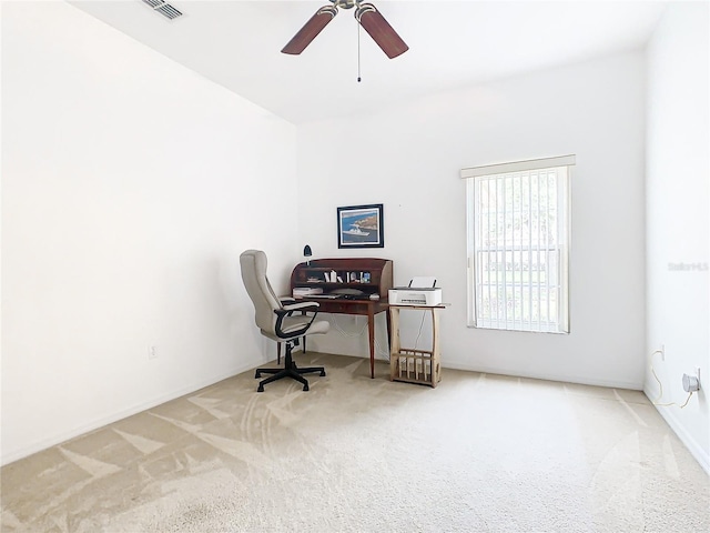 carpeted home office with ceiling fan