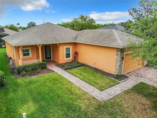 ranch-style home with a front yard and a garage