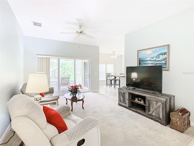 carpeted living room with ceiling fan