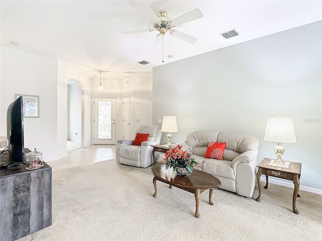 carpeted living room with ceiling fan