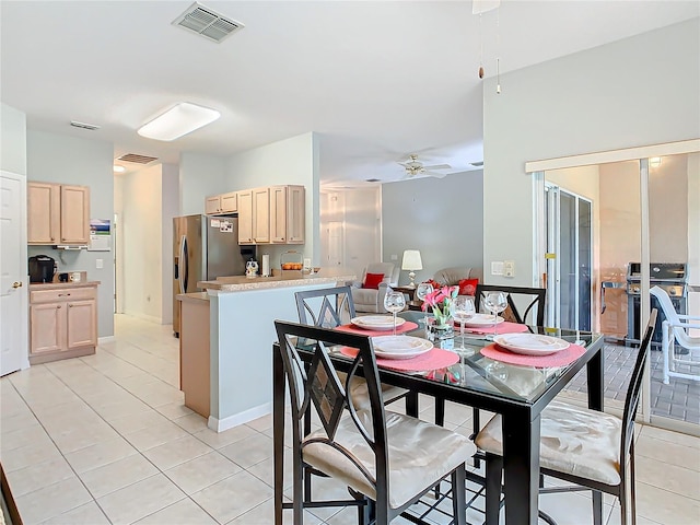 dining area with light tile floors and ceiling fan