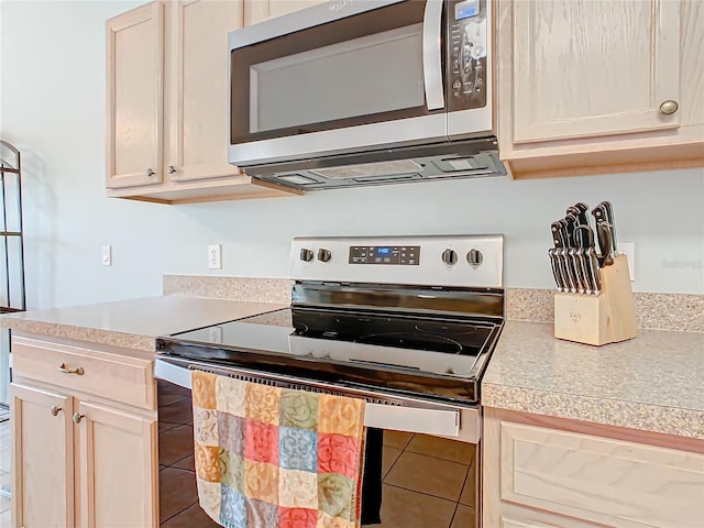 kitchen featuring tile floors and stainless steel appliances