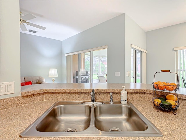 kitchen featuring ceiling fan and sink