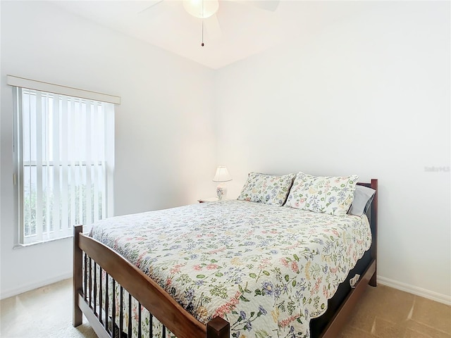 bedroom with light carpet and ceiling fan