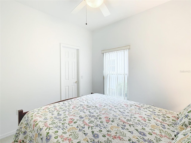 bedroom featuring ceiling fan and carpet