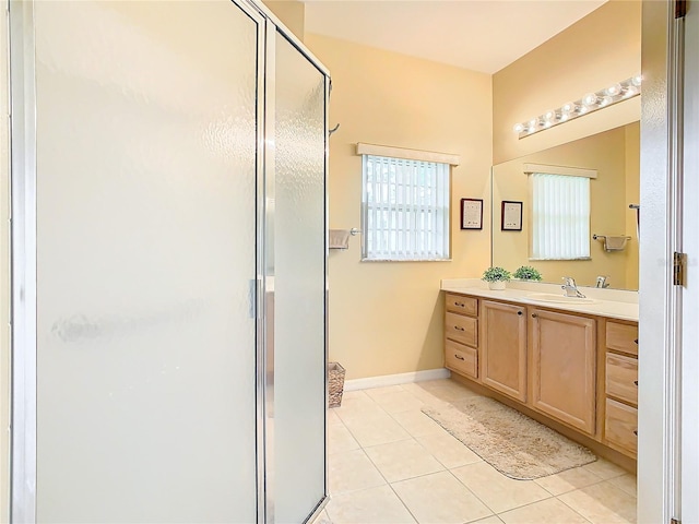 bathroom with vanity, a shower with shower door, and tile flooring