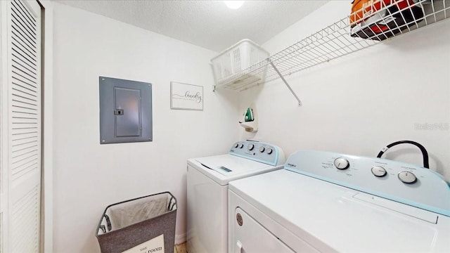 laundry area featuring a textured ceiling and separate washer and dryer