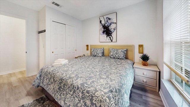 bedroom with a closet and light hardwood / wood-style flooring