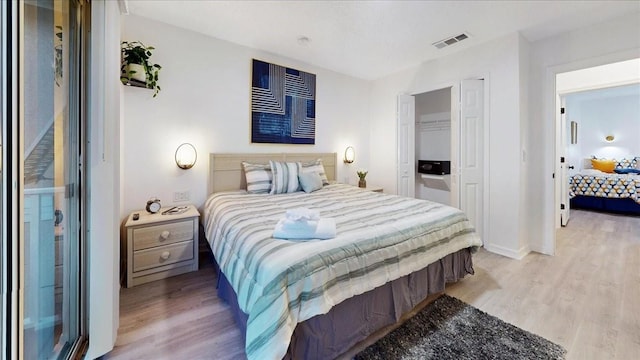 bedroom featuring a closet and light hardwood / wood-style flooring