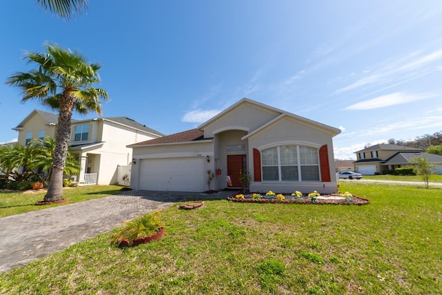 ranch-style house featuring a front lawn and a garage