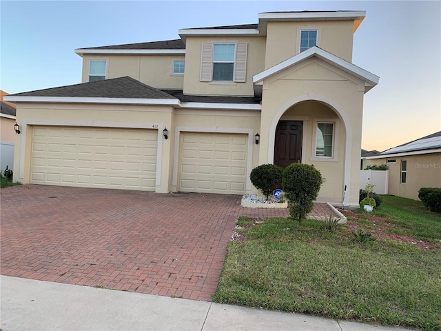 view of front facade with a garage and a yard