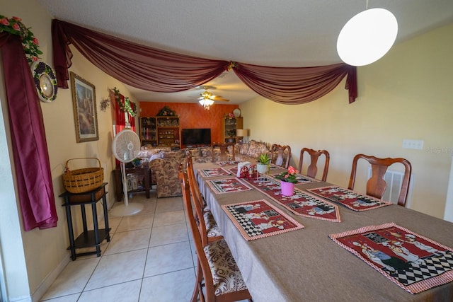 dining area with ceiling fan and light tile flooring