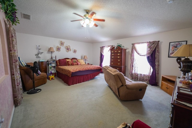 carpeted bedroom featuring a textured ceiling and ceiling fan