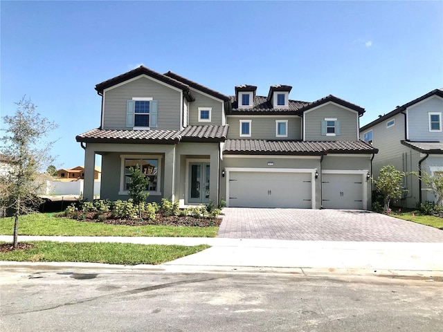 view of front facade featuring a front lawn and a garage