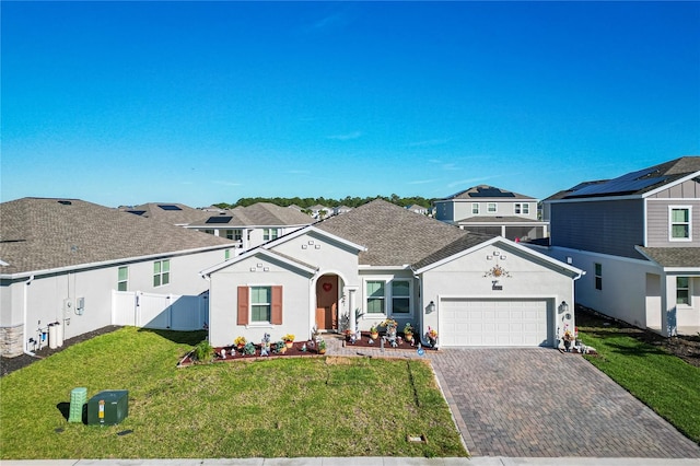 ranch-style house with a front lawn, solar panels, and a garage