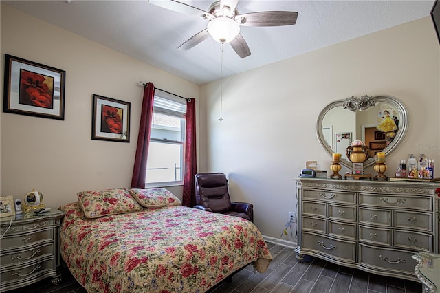 bedroom featuring ceiling fan and dark wood-type flooring