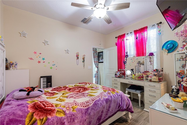 bedroom with ceiling fan and hardwood / wood-style flooring