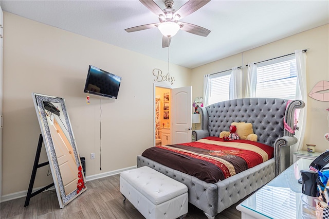 bedroom featuring connected bathroom, ceiling fan, and wood-type flooring