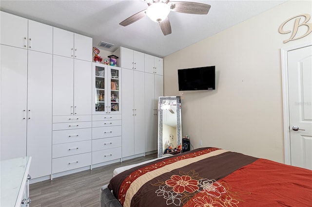 bedroom featuring vaulted ceiling, ceiling fan, and light hardwood / wood-style flooring