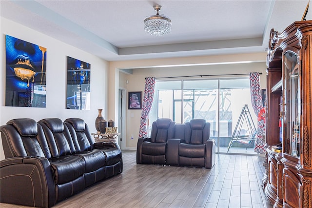 living room featuring a chandelier and light wood-type flooring