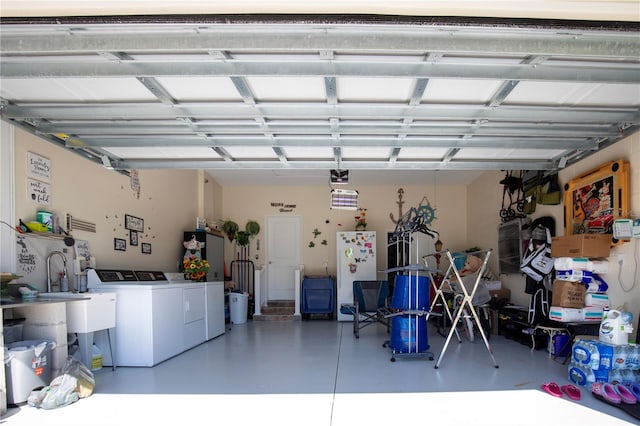 garage featuring washing machine and dryer and white fridge