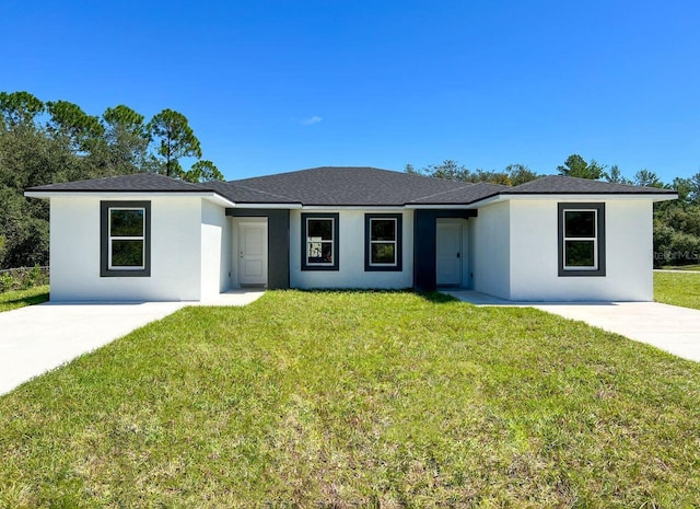 ranch-style house with a front yard and a patio area