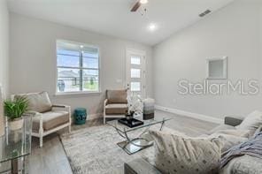 living room with vaulted ceiling, ceiling fan, and wood-type flooring