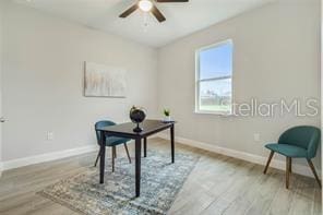 office with ceiling fan and light wood-type flooring