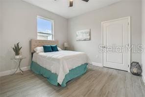 bedroom featuring wood-type flooring and ceiling fan