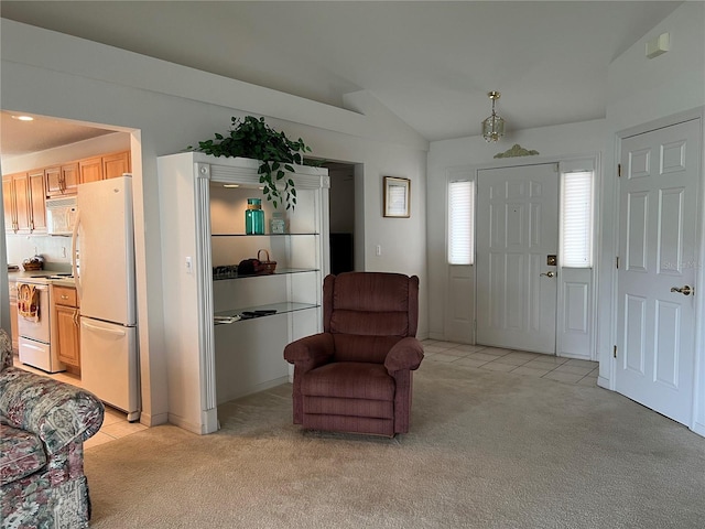 sitting room featuring lofted ceiling and light colored carpet