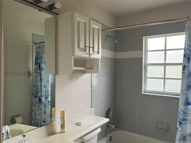 full bathroom featuring toilet, shower / bath combo with shower curtain, and sink