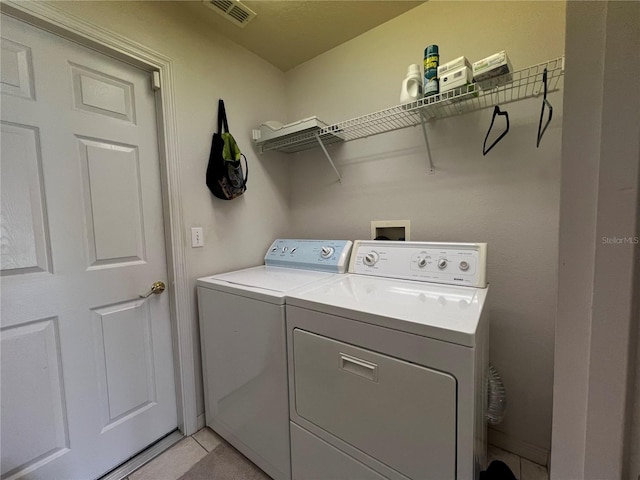 laundry room with washer hookup, independent washer and dryer, and light tile floors