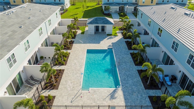 view of swimming pool featuring a lawn and a patio