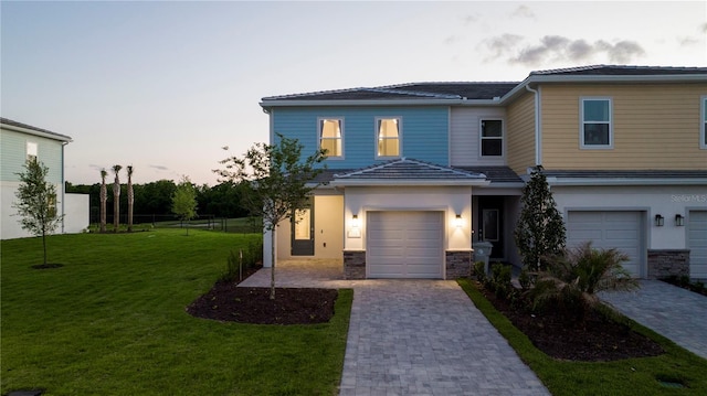 view of front of house with a yard and a garage