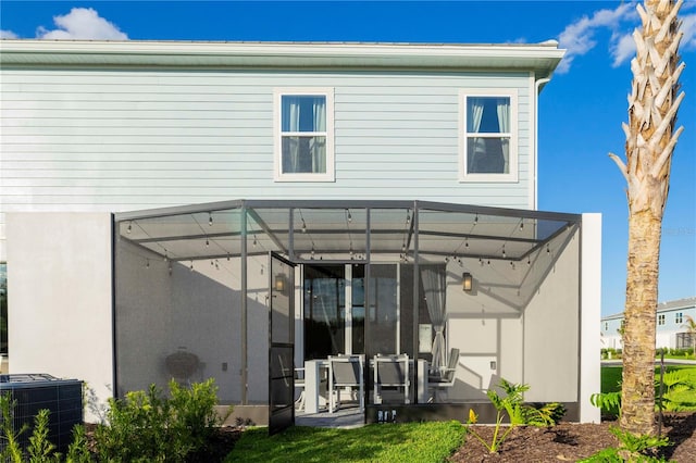 rear view of house featuring central air condition unit