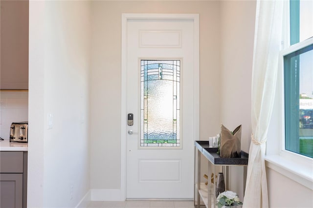 doorway with light tile floors